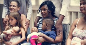 group postpartum visit with moms holding babies