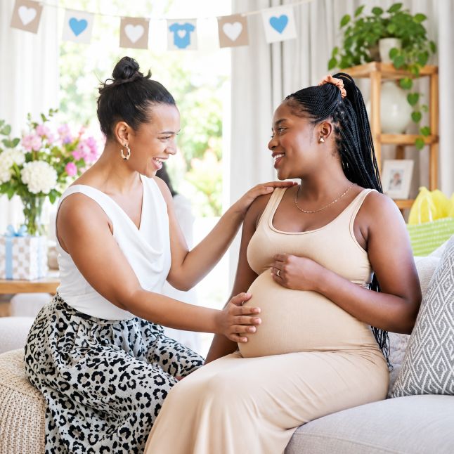 two women talking at a baby shower