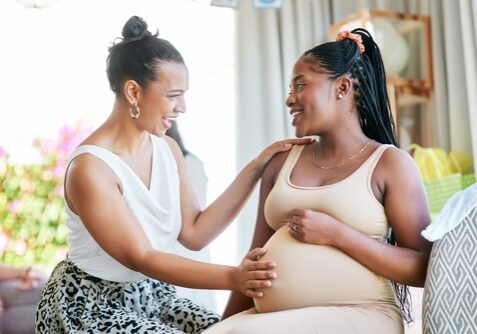 Woman supporting a pregnant woman, doula support for labor & birth